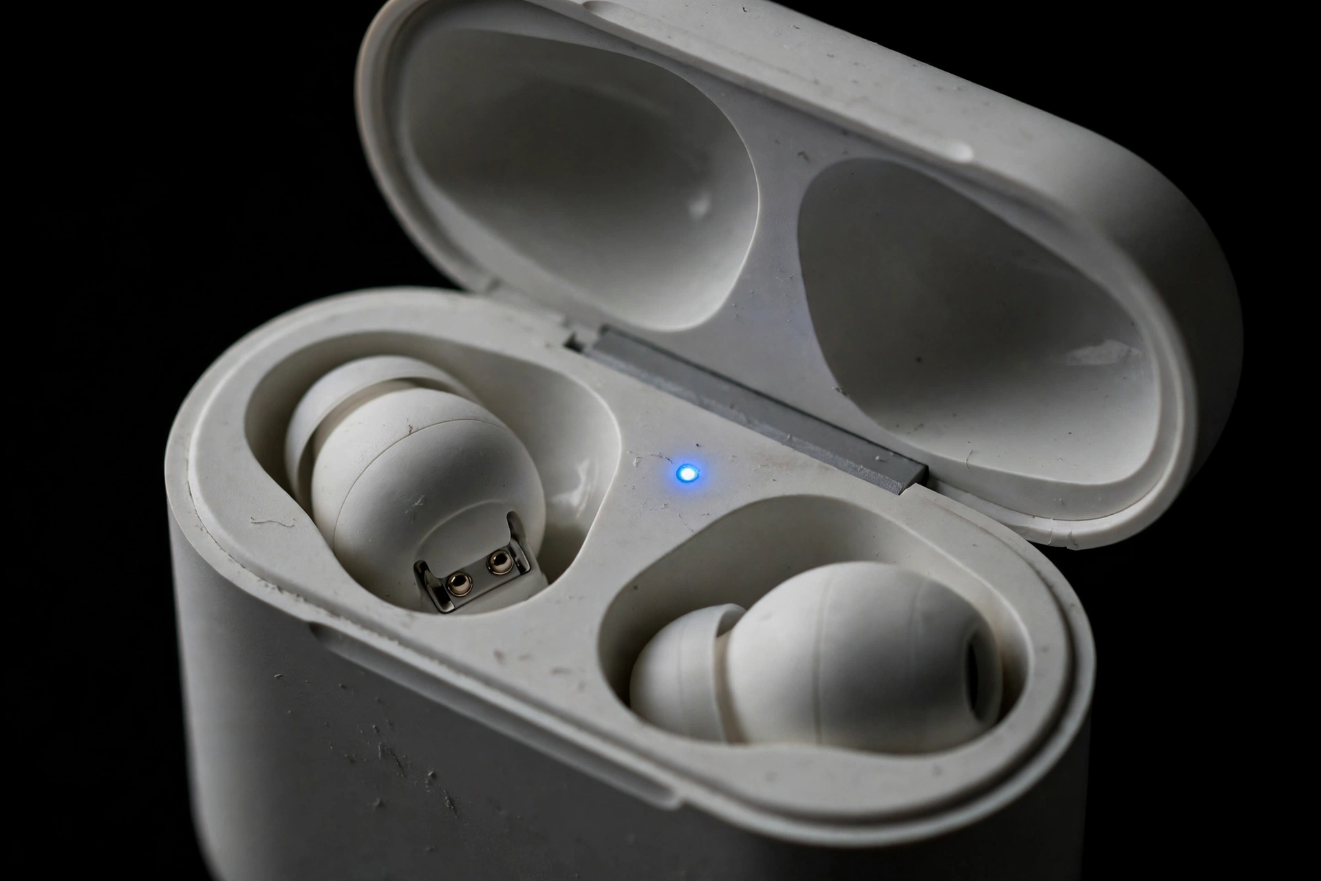 Bluetooth earbuds in pairing mode with flashing light