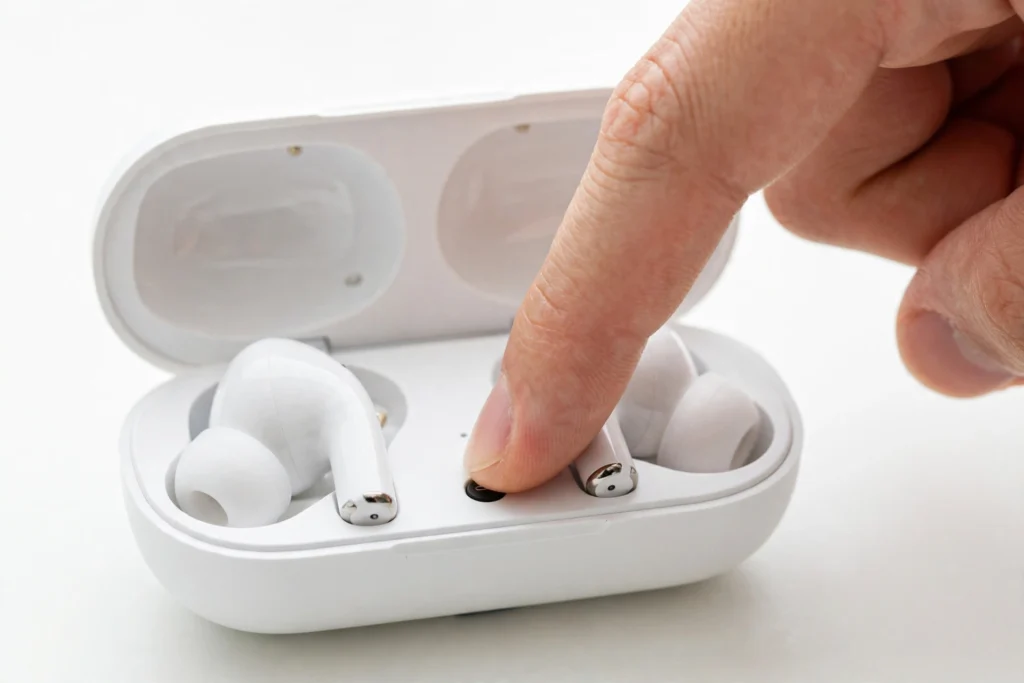 Putting Bluetooth earbuds into pairing mode with the charging case button